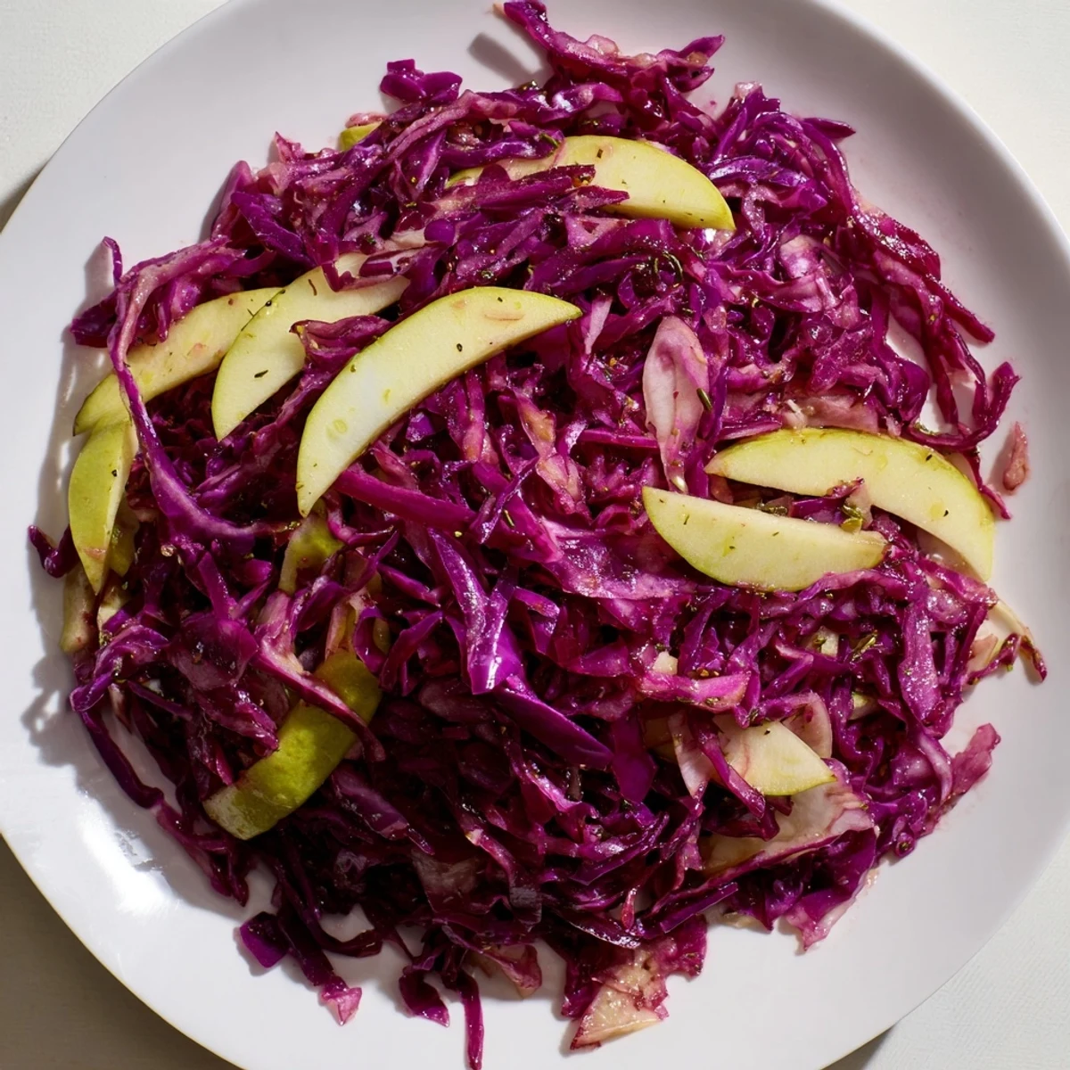 A vibrant plate of Sweet & Sour Bavarian Red Cabbage and Apples, a colorful German side dish.