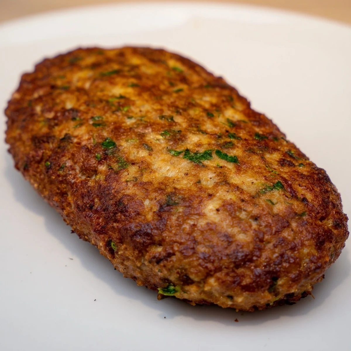 Golden-brown Frikadellen, German meatballs, sizzling in a pan, ready to be served hot.