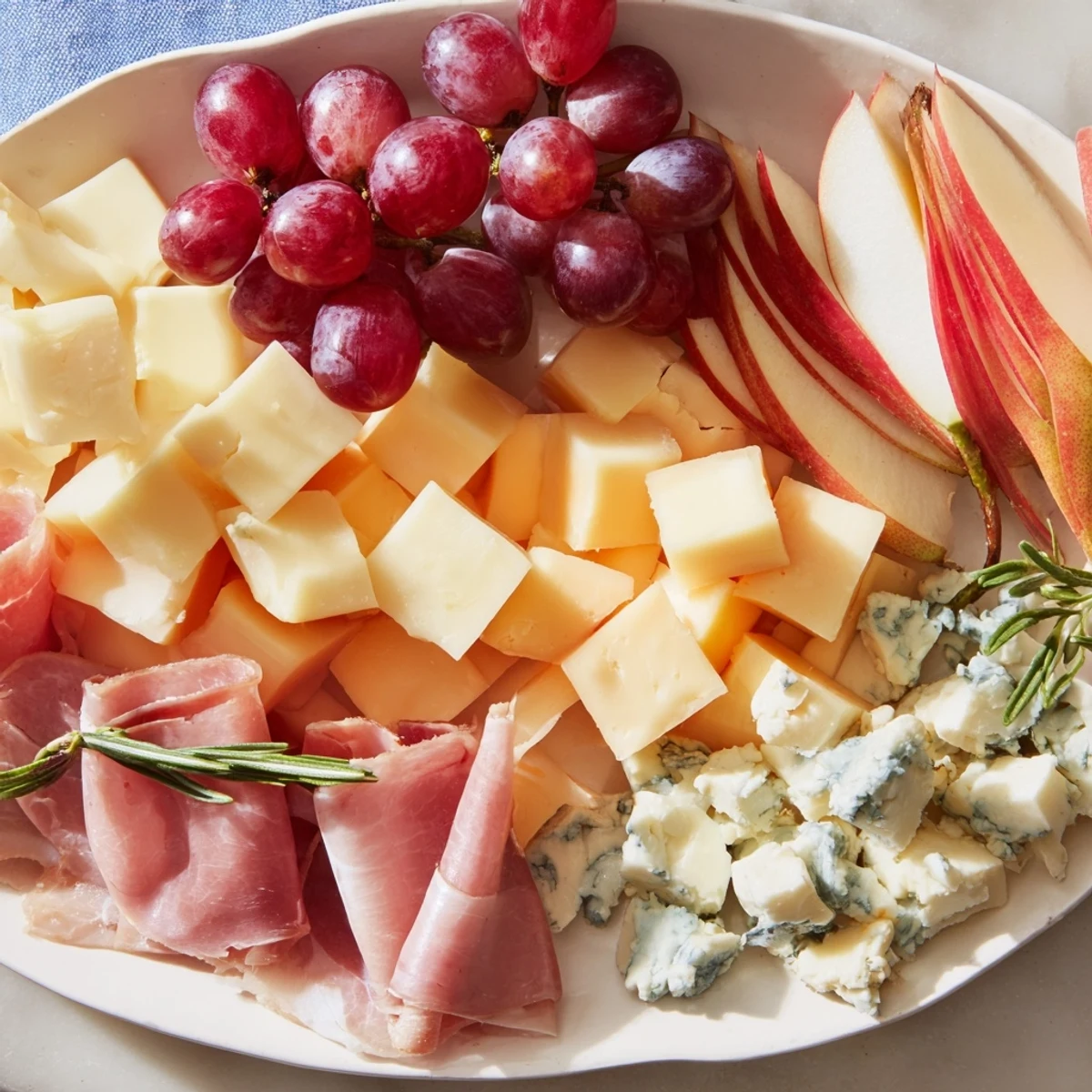 A delicious Sleigh Ride Charcuterie board overflowing with savory cheeses, plus flavorful meats and holiday goodies.