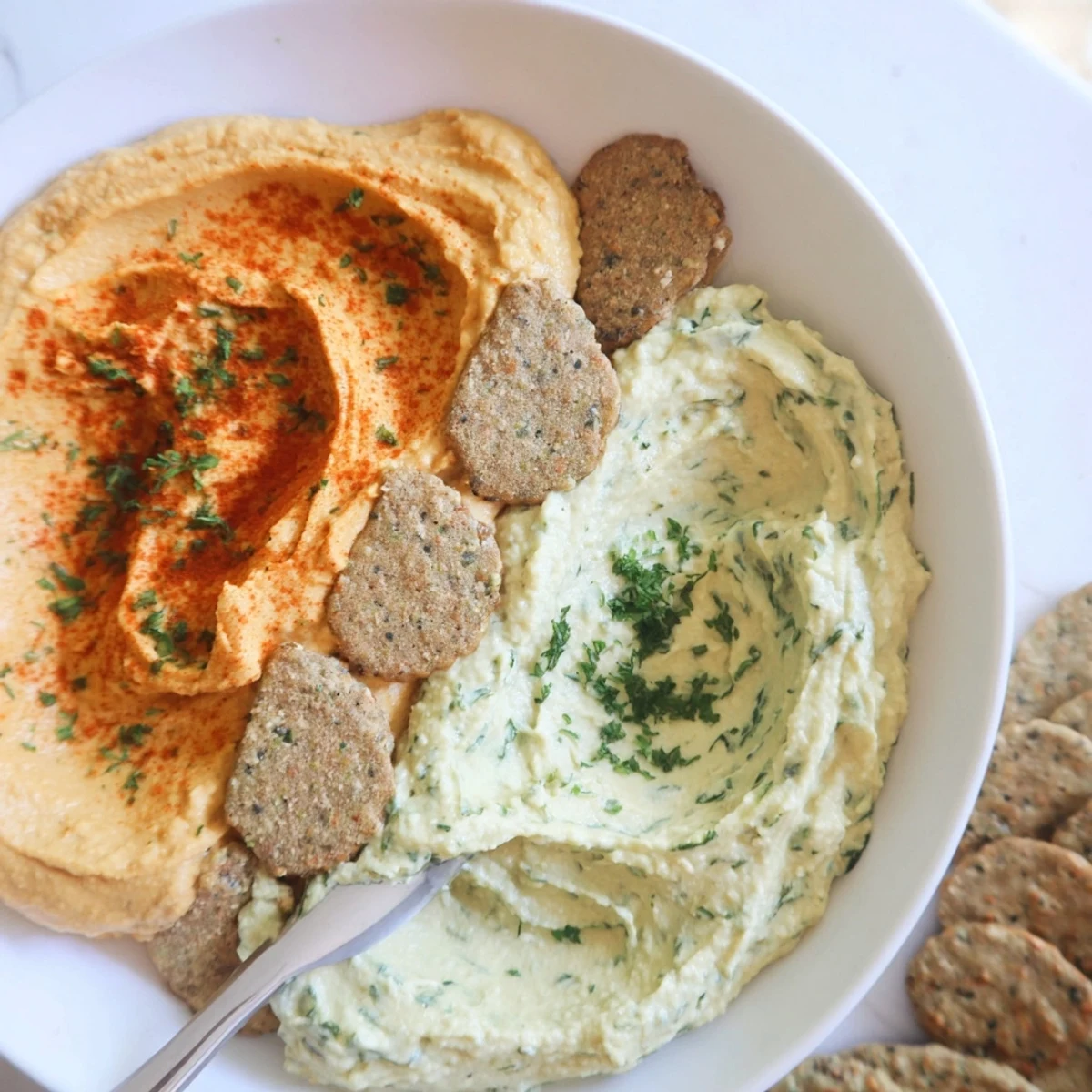 Two Dip Bowls with Cracker Divide Line: A beautiful overhead shot of the appetizer, ready to serve with crackers.