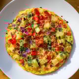 Warm, oven-baked Potato and Vegetable Frittata, featuring colorful vegetables, perfect for brunch.