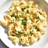 Freshly made spaetzle with a dusting of parsley, offering a simple yet comforting flavor.