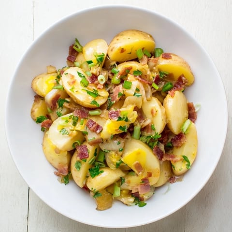 Warm German Potato Salad: a bowl brimming with tender potatoes and crispy bacon, ready to serve.