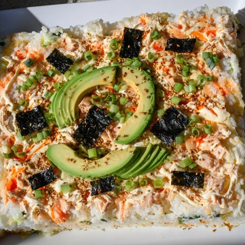 Warm, savory Sushi Bake Casserole, a delightful mix of rice, salmon, and creamy avocado, ready to serve. 