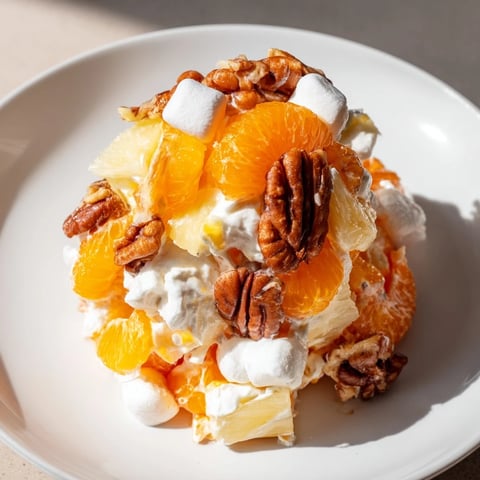 Creamy elevated Ambrosia Salad, rich with mandarin oranges, marshmallows, and toasted pecans, ready to chill.