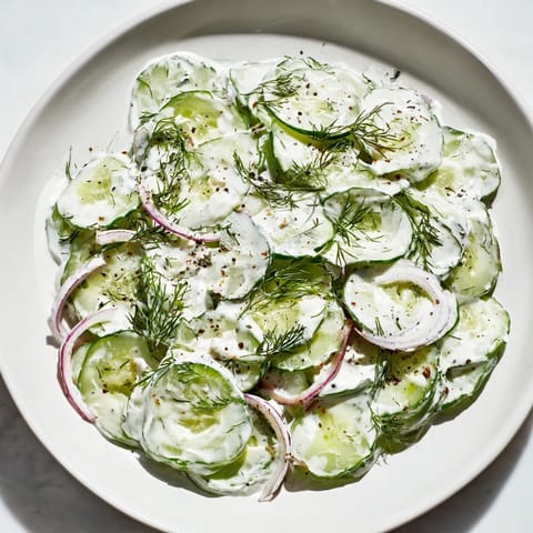 Creamy Omas German Cucumber Salad with fresh dill is a vibrant summer side dish.