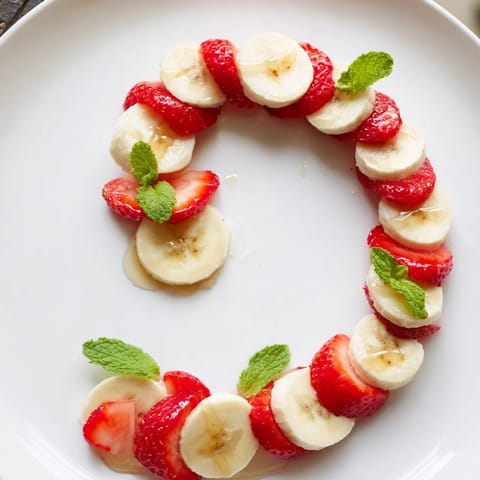 Bright red strawberries and banana slices compose adorable Banana Strawberry Candy Canes, ready to eat.