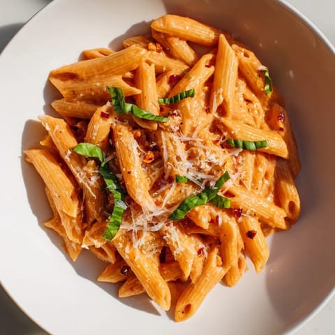 A close-up of the easy Basil Garlic One-Pot Creamy Tomato Pasta, garnished with fresh basil.