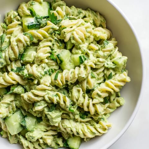 Green Goddess Pasta Salad showcases crisp cucumber, fusilli pasta, and a bright herb dressing on a plate.  