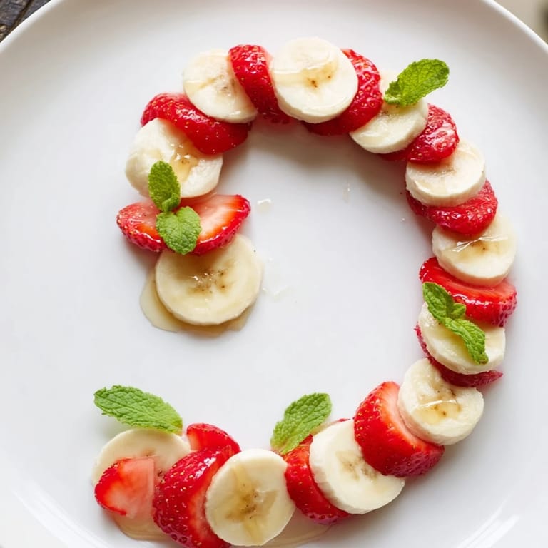 Bright red strawberries and banana slices compose adorable Banana Strawberry Candy Canes, ready to eat.