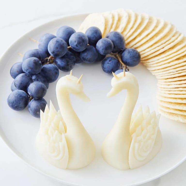 An overhead view shows the Elegant Swan Lake Board with swan carvings, grapes, and crackers ready to enjoy.
