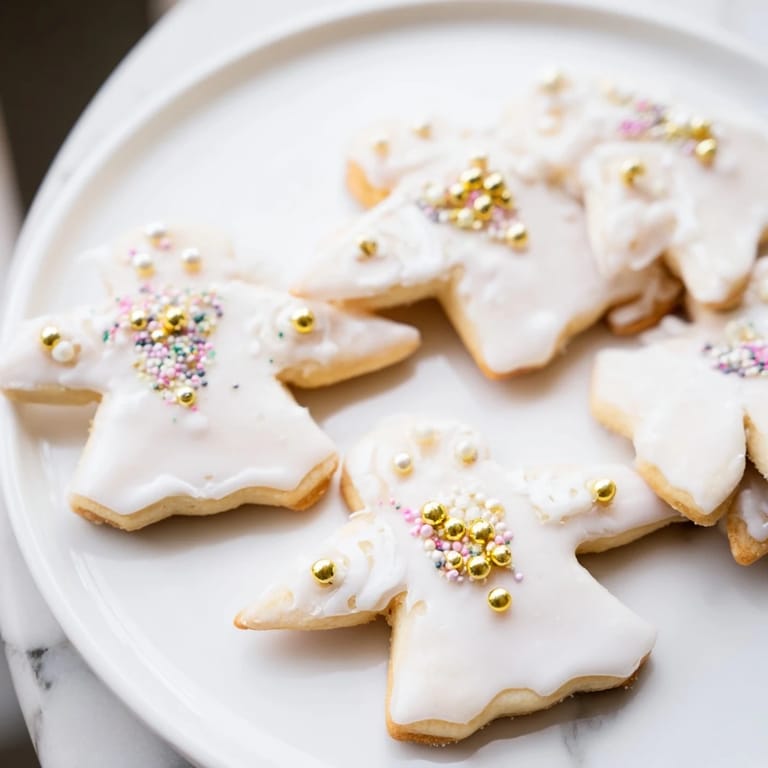 These delicate Biscuits Anges de Noël, shaped like angels, feature a light, vanilla-infused shortbread flavor.