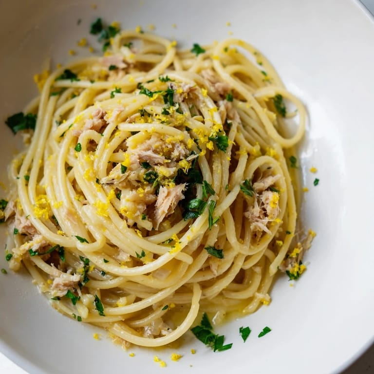 A close-up of Lemon-Garlic Tuna Spaghetti, pasta glistening in a flavorful garlic and lemon sauce.