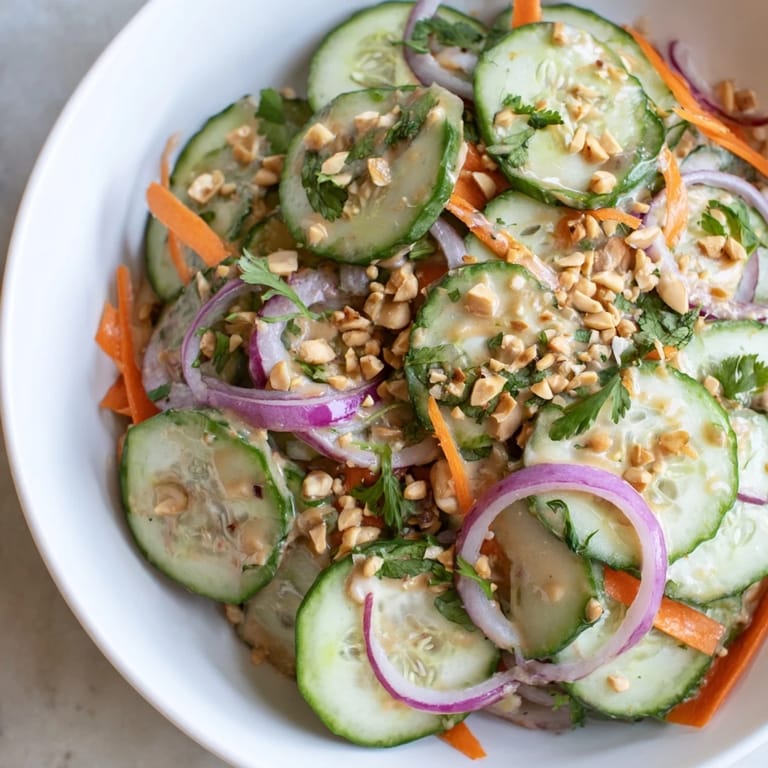 A close-up of the flavorful Thai-Style Peanut Cucumber Salad, ready to eat with sesame seeds.