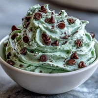 Festlicher, cremiger Minz-Schokoladen-Chip-Dip mit frischer Minze und Schokostückchen.